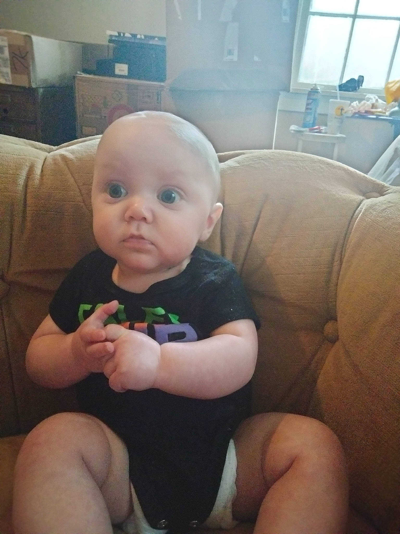 River is registered to the contest to win money with this photo: baby, baby_toddler_clothing, cheek, child, chin, comfort, couch, eye, face, head, human_body, iris, lap, leg, person, skin, standing, surprise, thigh, thumb