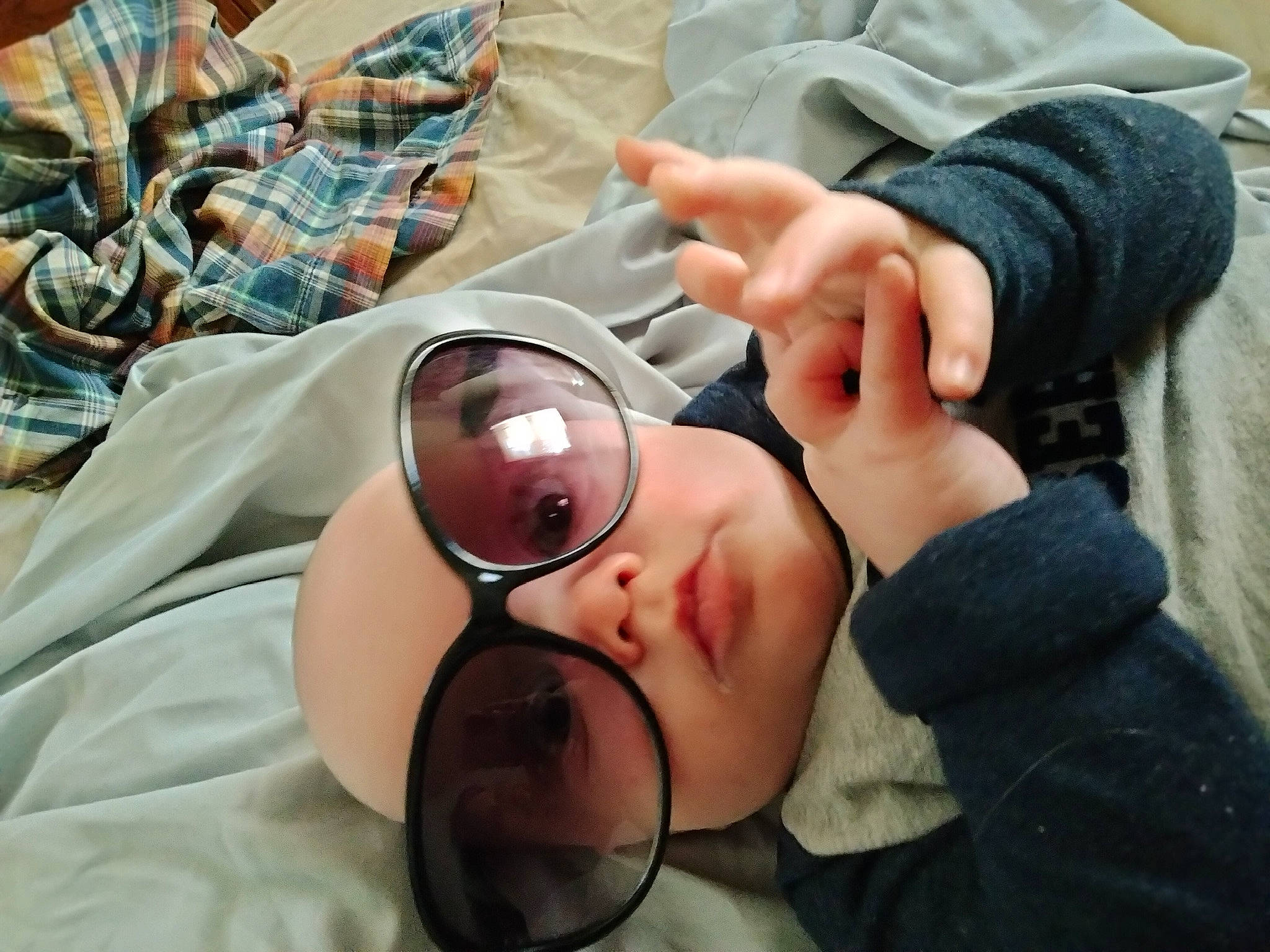 River is registered to the contest to win money with this photo: baby, comfort, eyewear, finger, foot, gesture, glasses, goggles, hand, happy, headwear, human_body, human_leg, mouth, nail, person, service, skin, sunglasses, thumb
