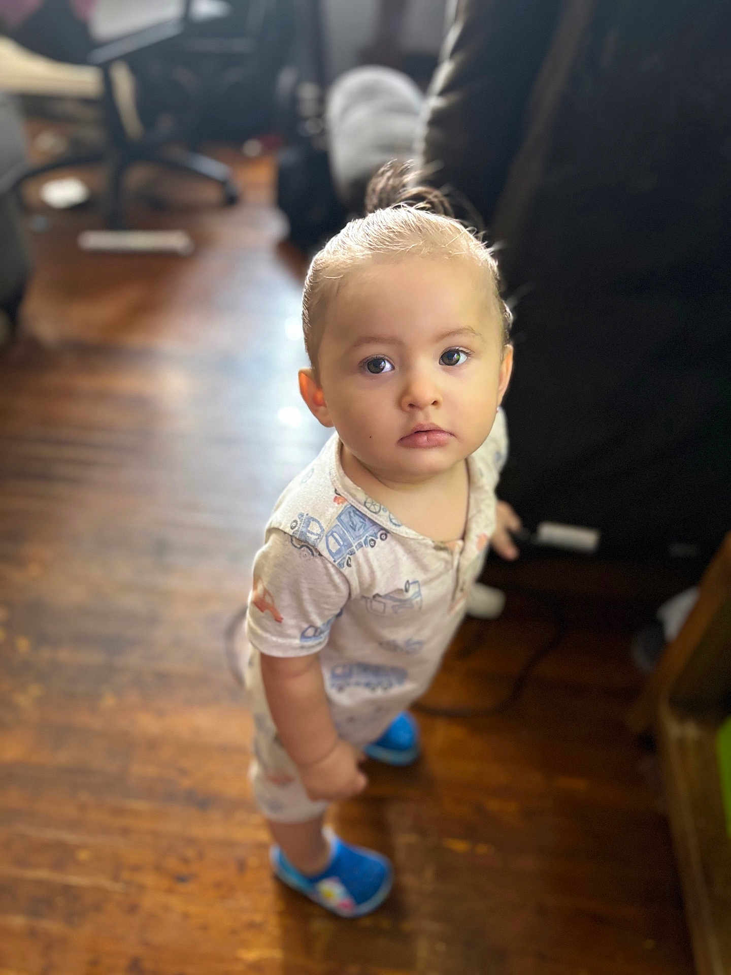 Jadeziah joined the competition — help win amazing prizes! toddler, child, indoor, wooden_floor, pajamas, blue_shoes, curious, standing, person, face, young_child, hair_tied, footwear, home, blurred_background, furniture, expression, looking_up, casual_clothing, cute
