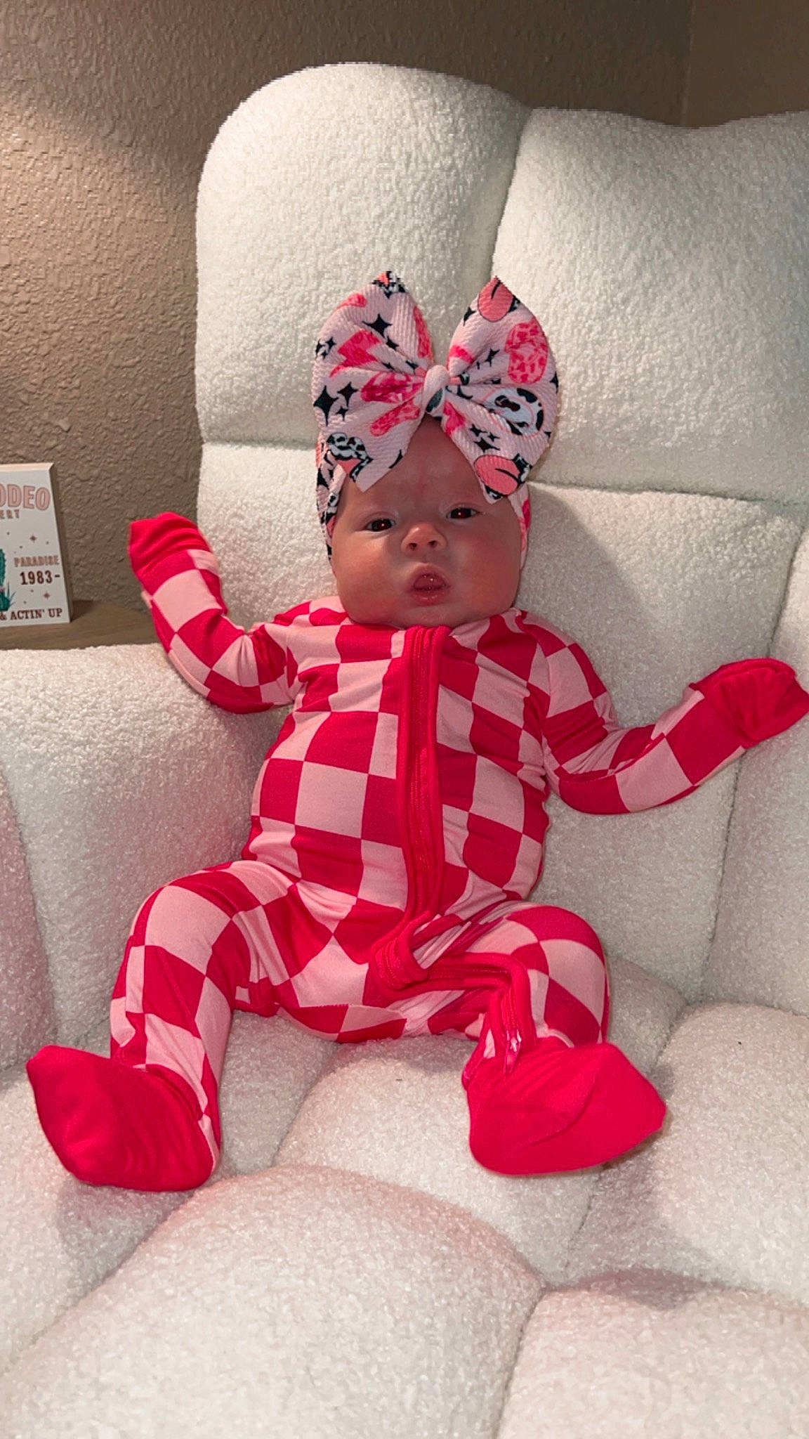 Kinslee is registered to the contest to win money with this photo: baby, baby_toddler_clothing, beanie, cap, carmine, comfort, costume, costume_hat, fashion_accessory, fictional_character, happy, head, headwear, lap, linens, magenta, pattern, person, pink, sitting