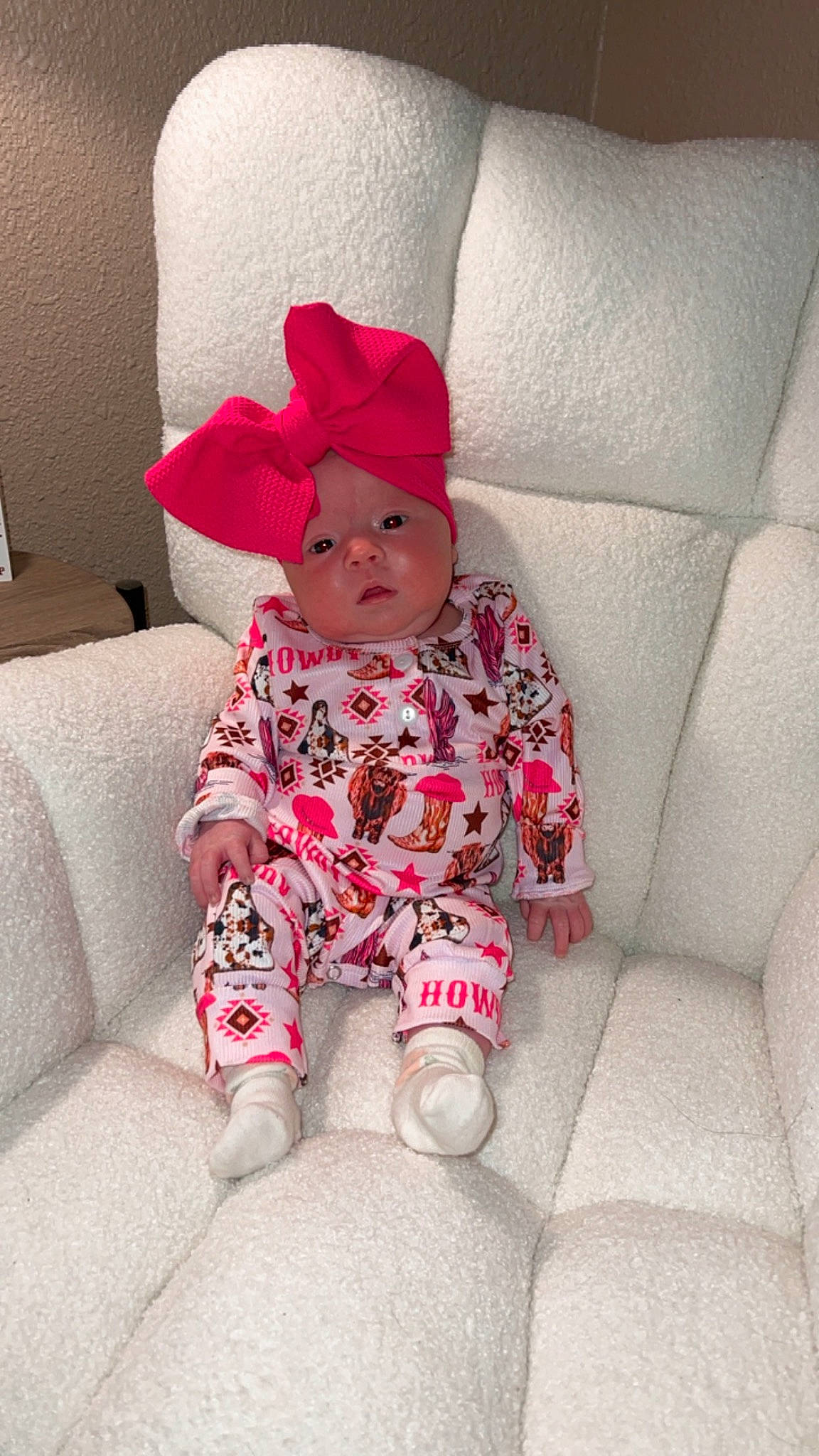 Kinslee is registered to the contest to win money with this photo: baby, baby_toddler_clothing, beanie, carmine, child, comfort, couch, foot, head, headwear, hood, linens, magenta, outerwear, pattern, person, pink, sitting, sleeve, sock