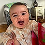 Roman is registered to the contest to win money with this photo: baby, child, smiling, happy, blanket, hand, sweater, indoor, furniture, lamp, chair, table, slippers, wood_floor, person, face, portrait, cozy, home, cute
