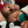 Dahari is registered to the contest to win money with this photo: baby, adult, sleeping, pacifier, blanket, red_hair, face, closeup, lying_down, indoor, comfort, rest, family, tender, skin, person, soft_texture, cozy, portrait, relaxation