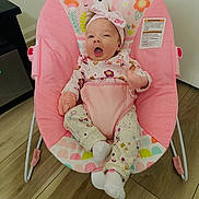 Ellani Raelynn joined the competition — help win amazing prizes! baby, infant, child, pink, unicorn, baby_chair, headband, hello_kitty, pajamas, floral_pattern, wooden_floor, indoor, smiling, happy, seated, cute, cozy, home, toy, colorful