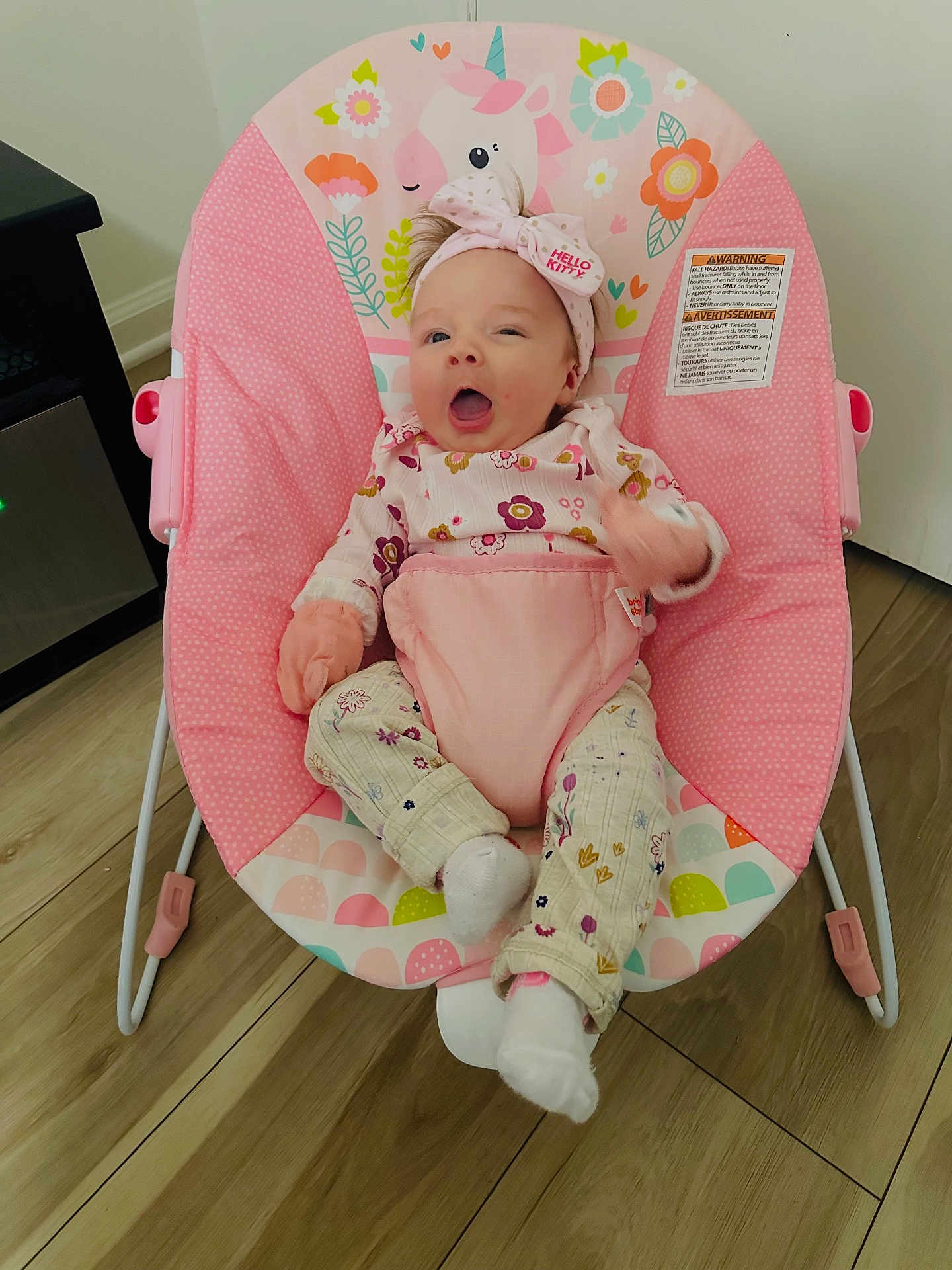 Ellani Raelynn joined the competition — help win amazing prizes! baby, infant, child, pink, unicorn, baby_chair, headband, hello_kitty, pajamas, floral_pattern, wooden_floor, indoor, smiling, happy, seated, cute, cozy, home, toy, colorful