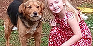 Lil Wayne Einstein is registered to the contest to win money with this photo: dog, child, girl, grass, outdoor, smile, pet, animal, happy, crouching, clothing, tail, playful, person, nature, friendship, yard, casual, young, daylight