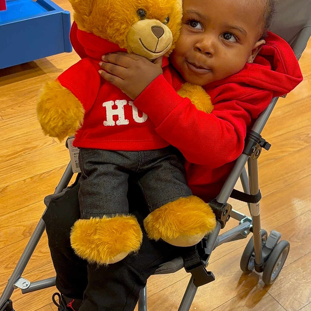 Shareef joined the competition — help win amazing prizes! baby, chair, clothing, face, footwear, furniture, hardwood, head, machine, pants, person, photography, portrait, shoe, sitting, stroller, teddybear, toy, wheel, wood
