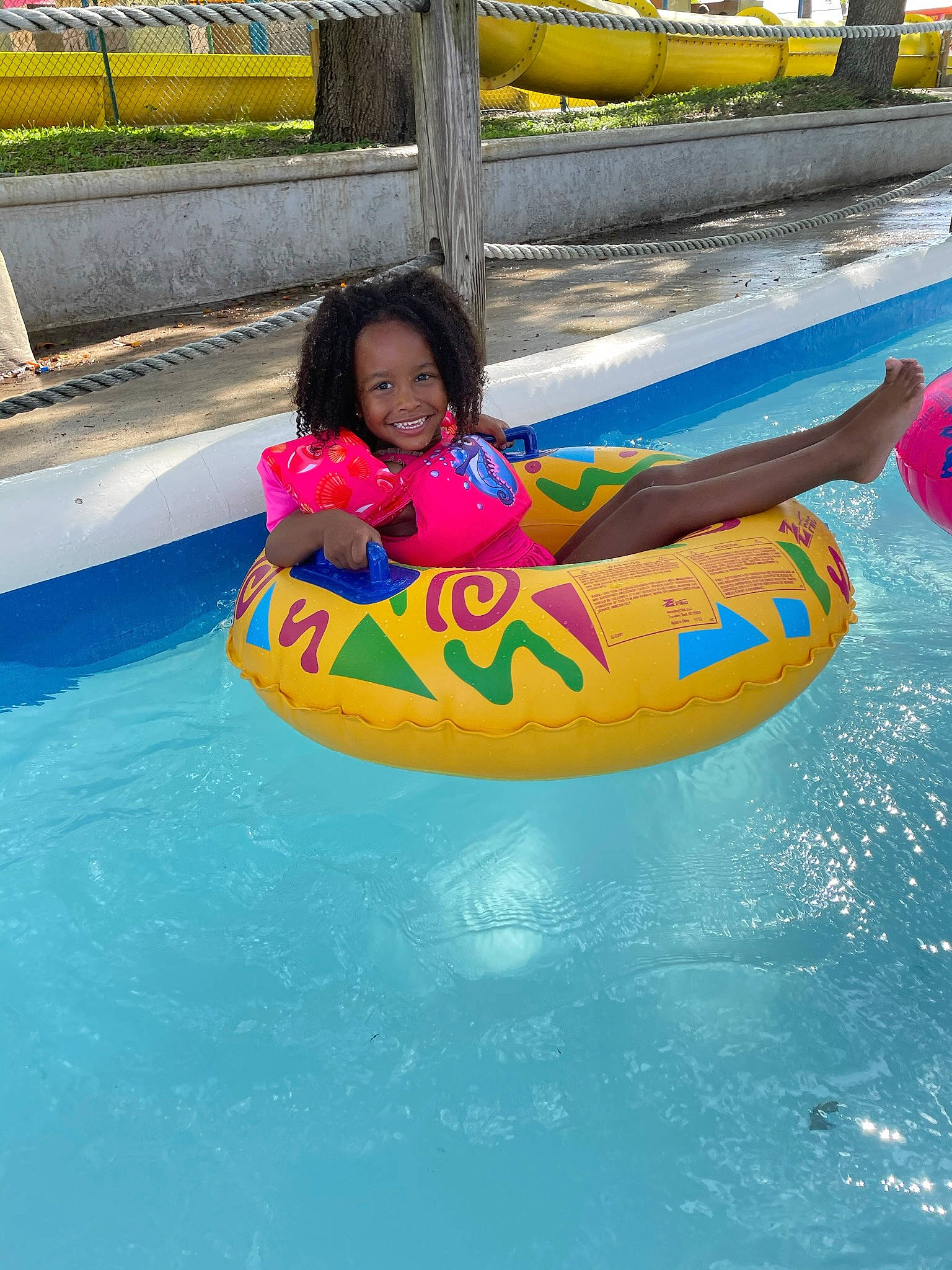 Jianni is registered to the contest to win money with this photo: amusement_ride, baby, baby_float, boats_and_boating_equipment_and_supplies, chute, fun, happy, inflatable, joy, leisure, outdoor_play_equipment, outdoor_recreation, person, personal_protective_equipment, recreation, smile, summer, swimming_pool, toddler, tubing