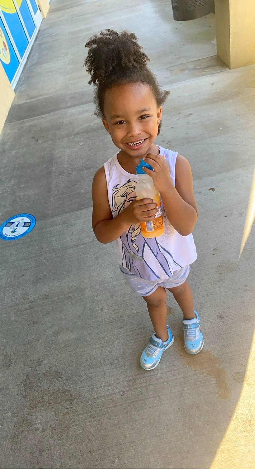 Jianni is registered to the contest to win money with this photo: arm, asphalt, child, clothing, fun, happy, human_leg, joint, joy, leisure, person, public_space, recreation, road, shorts, smile, street, t_shirt, thigh, toddler