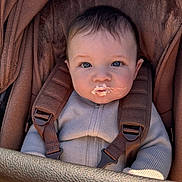 Reign joined the competition — help win amazing prizes! baby, child, stroller, brown, blue_eyes, cream, mustache, clothing, seatbelt, cute, infant, portrait, cozy, hands, soft, warm, outdoor, baby_clothes, closeup, young