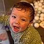 toddler, child, smiling, happy, face, eyes, sweater, knitted, green, indoor, toy, balls, blurred_background, portrait, cute, baby, person, play, young, expression