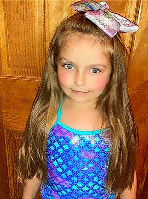 Kaitlyn is registered to the contest to win money with this photo: brown_hair, child, child_model, clothing, costume_accessory, fashion_accessory, hair, hair_accessory, hairstyle, headband, headgear, joy, long_hair, neck, person, smile, toddler