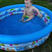 Lainee is registered to the contest to win money with this photo: baby, blue, child, cute, diaper, grass, green, happy, inflatable_pool, outdoor, pacifier, play, pool, sitting, splashing, summer, sunlight, toy, water, young