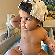Kenny is registered to the contest to win money with this photo: aquarium, arm, baby, baseball_cap, cap, child, chubby, curious, diaper, face, fish, indoor, leg, light, medical_table, poster, room, sitting, skin, toddler