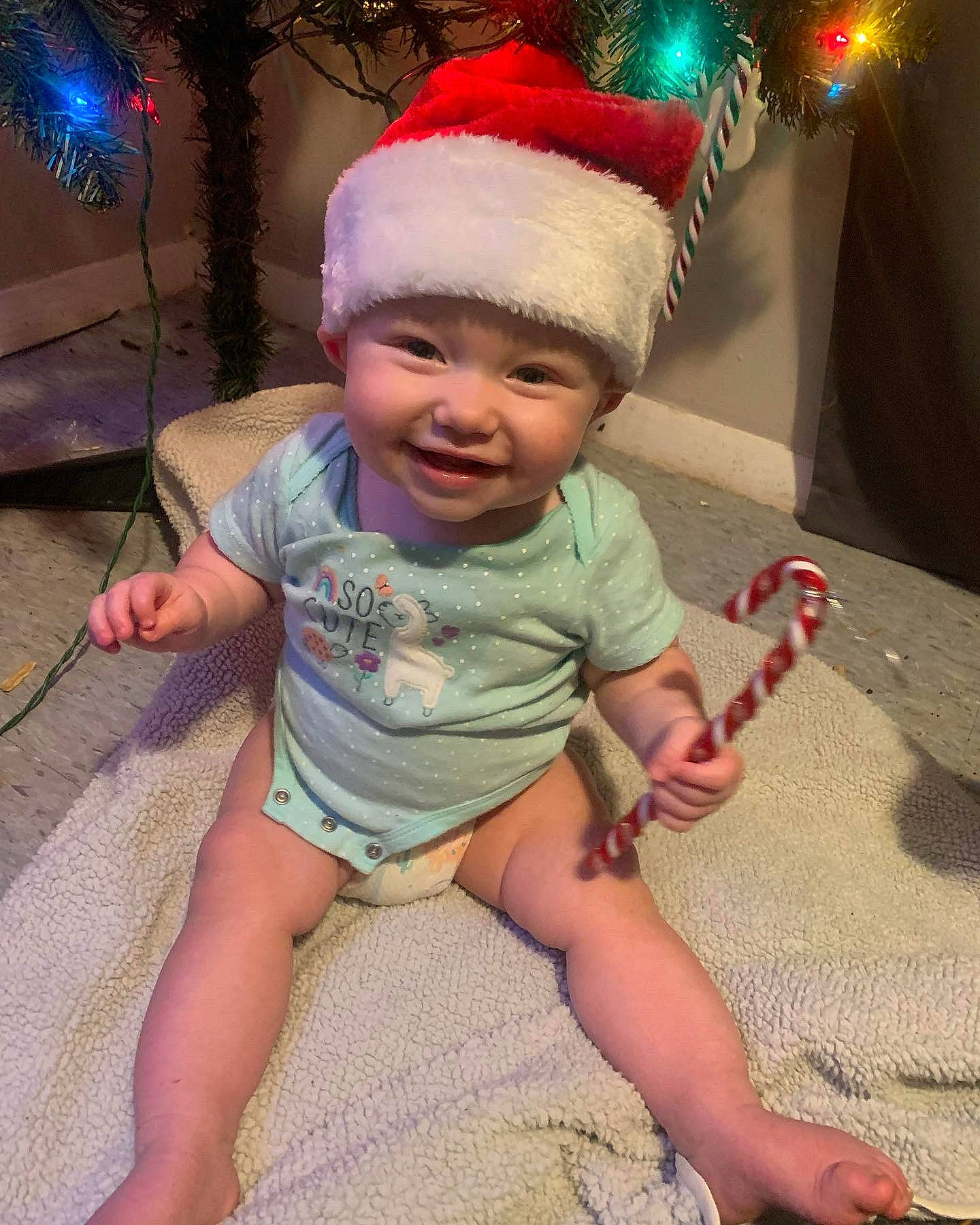 Adalynn is registered to the contest to win money with this photo: baby, baby_toddler_clothing, cap, child, christmas_ornament, costume_hat, event, foot, fun, happy, hat, head, headwear, holiday, joy, lap, leg, person, pink, shorts