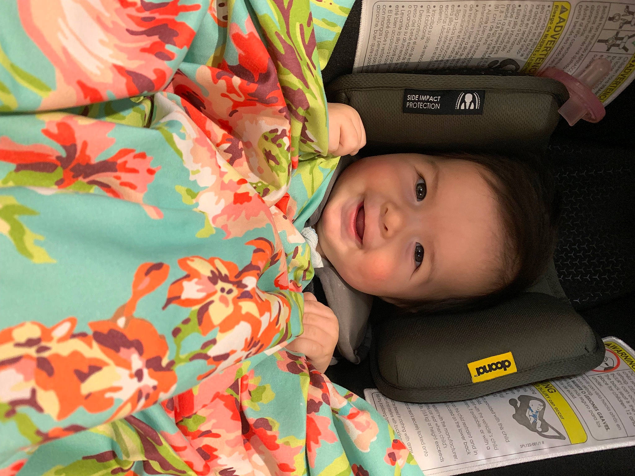 Rylee is registered to the contest to win money with this photo: baby, baby_carriage, baby_products, baby_toddler_clothing, bag, car_seat, carmine, child, comfort, eye, fashion_accessory, green, head, joy, linens, luggage_and_bags, orange, pattern, person, plant