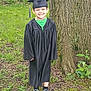 Nickalus joined the competition — help win amazing prizes! child, smiling, graduation_gown, graduation_cap, outdoor, tree, grass, greenery, happy, portrait, young, person, footwear, shoes, nature, celebration, event, standing, casual, daylight