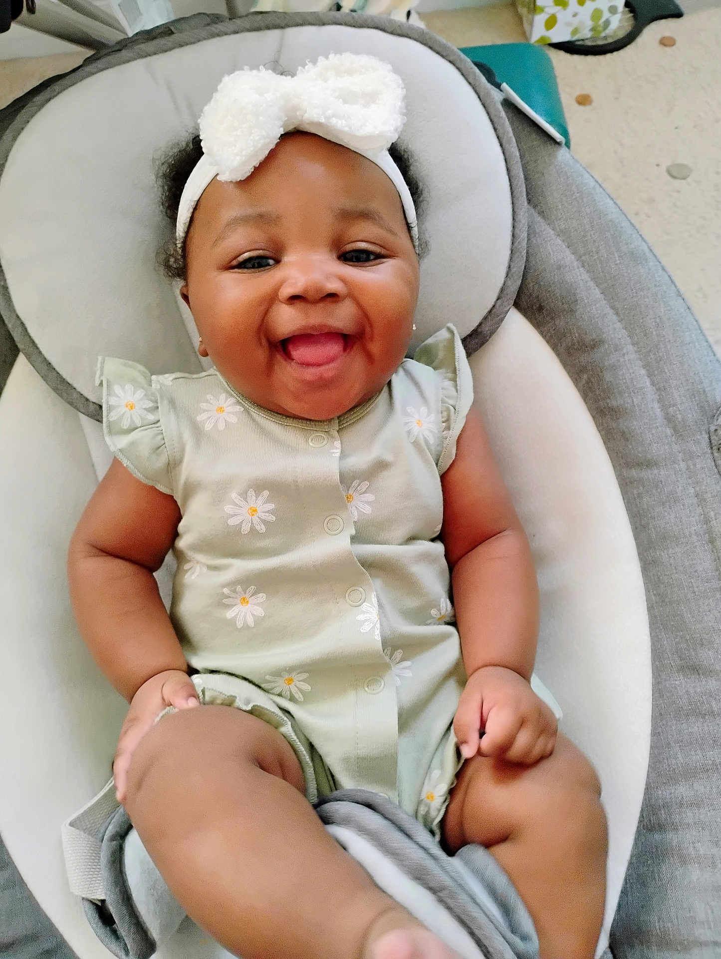Ariah joined the competition — help win amazing prizes! baby, smiling, infant, headband, onesie, flower_pattern, cute, happy, child, seat, cushion, indoor, skin, hand, foot, apparel, portrait, young, person, comfort