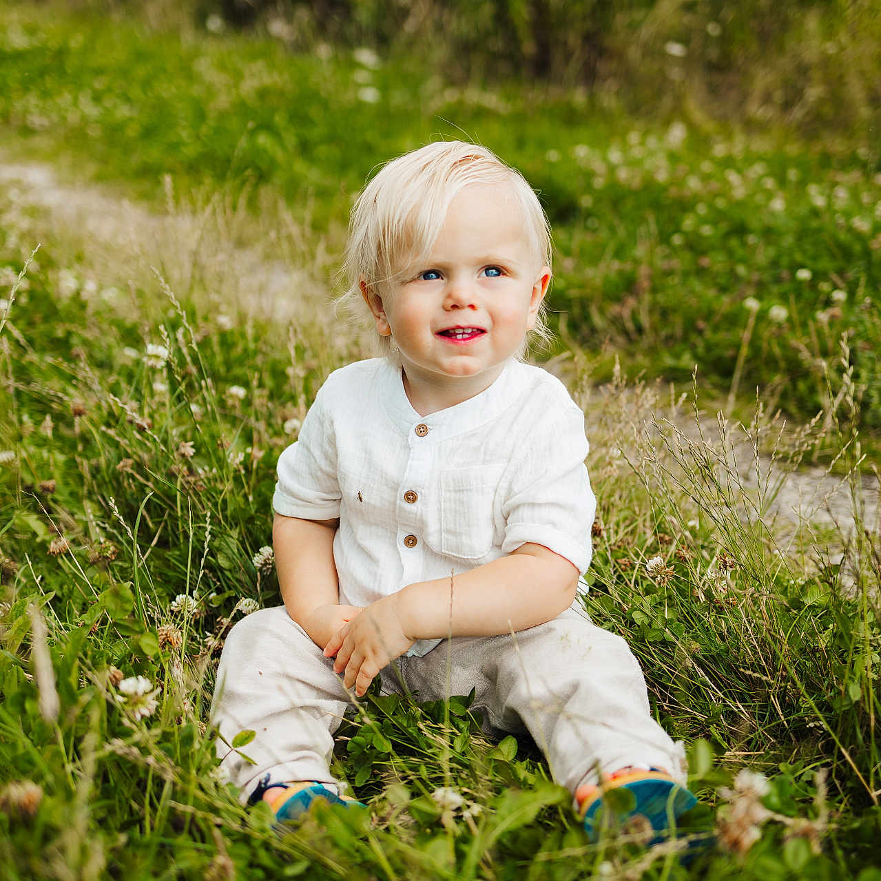 Stewart is registered to the contest to win money with this photo: boy, child, clothing, face, field, grass, grassland, happy, head, lawn, male, nature, outdoors, pants, person, photography, plant, portrait, sitting, smile
