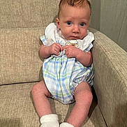 Hank joined the competition — help win amazing prizes! baby, infant, child, couch, sofa, clothing, socks, indoor, furniture, person, portrait, cute, young, seated, looking_at_camera, hands, feet, plaid, fabric, skin