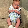 baby, infant, child, couch, sofa, clothing, socks, indoor, furniture, person, portrait, cute, young, seated, looking_at_camera, hands, feet, plaid, fabric, skin