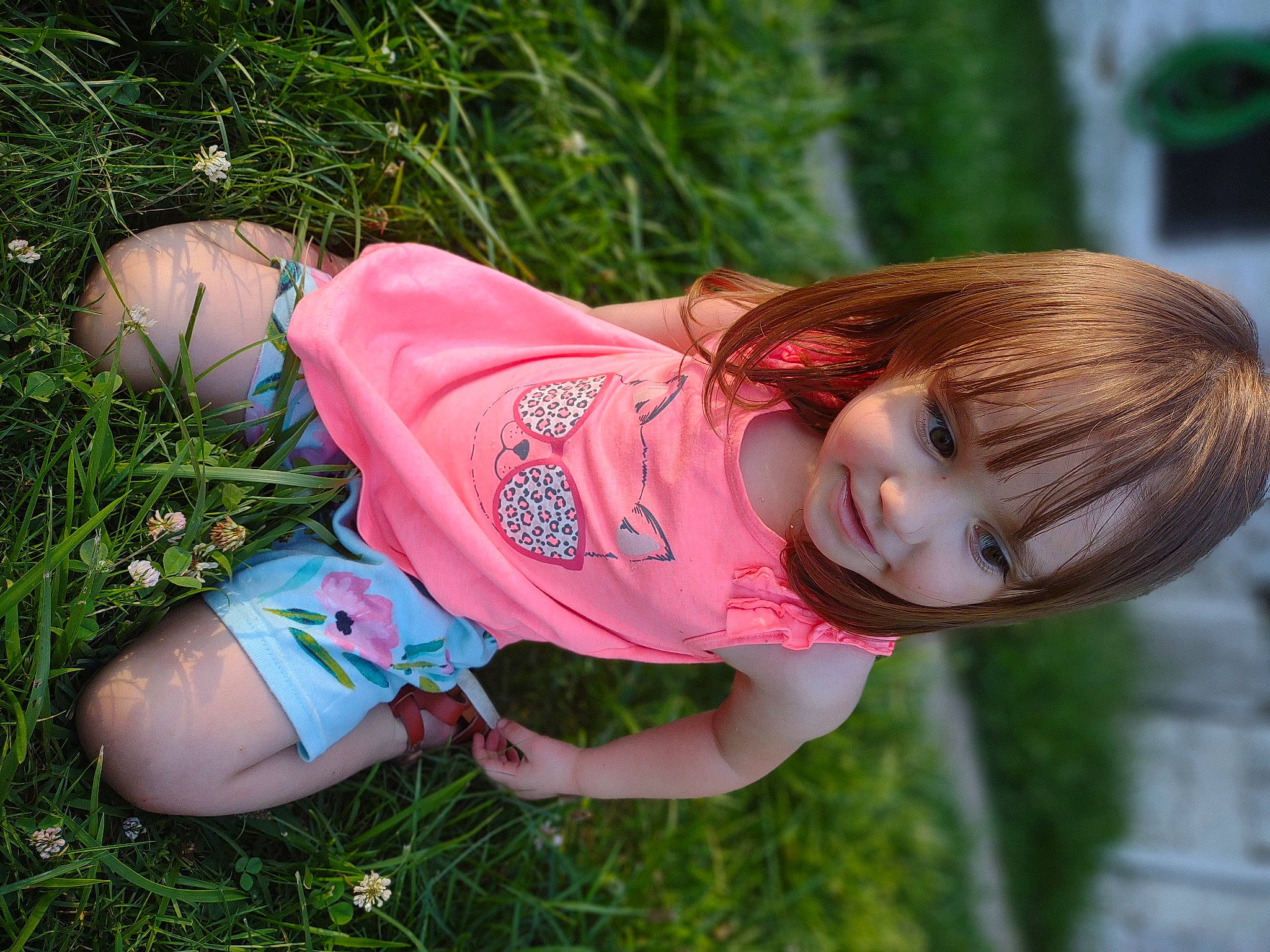Lillian-jean is registered to the contest to win money with this photo: bangs, blond, brown_hair, child, cool, fun, grass, happy, hat, human_leg, leisure, magenta, pattern, people_in_nature, person, pink, plant, t_shirt, thigh, toddler