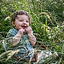 Tiago participe au concours pour gagner de l'argent avec cette photo : toddler, child, grass, greenery, nature, basket, happy, curly_hair, outdoor, smiling, playful, sitting, daylight, cute, portrait, innocence, blades_of_grass, casual_clothing, barefoot, summer