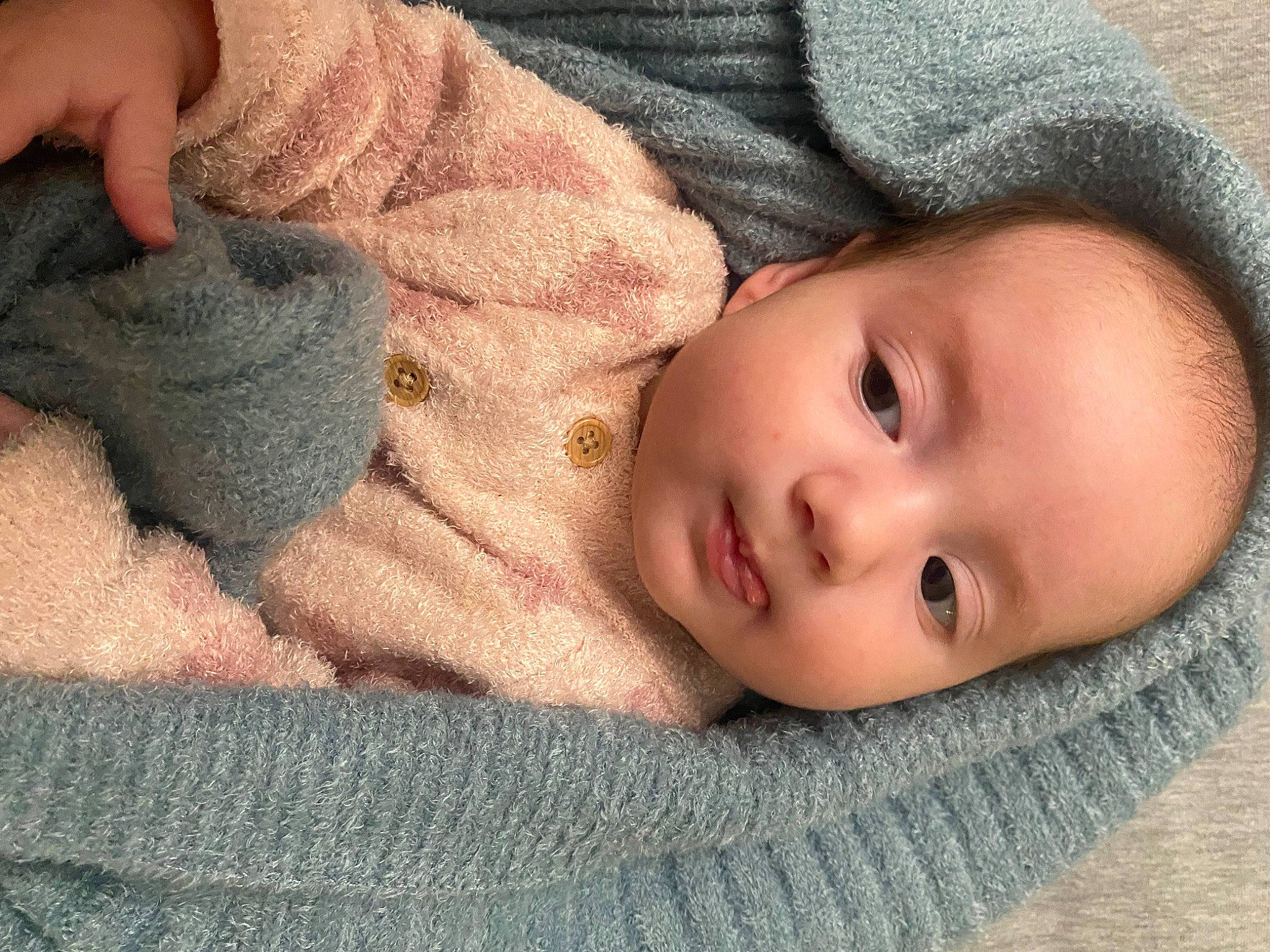 Evangeline is registered to the contest to win money with this photo: baby, baby_toddler_clothing, cheek, child, comfort, eyelash, gesture, head, iris, linens, lip, mammal, nose, person, skin, sleeve, textile, toddler, vertebrate, wood