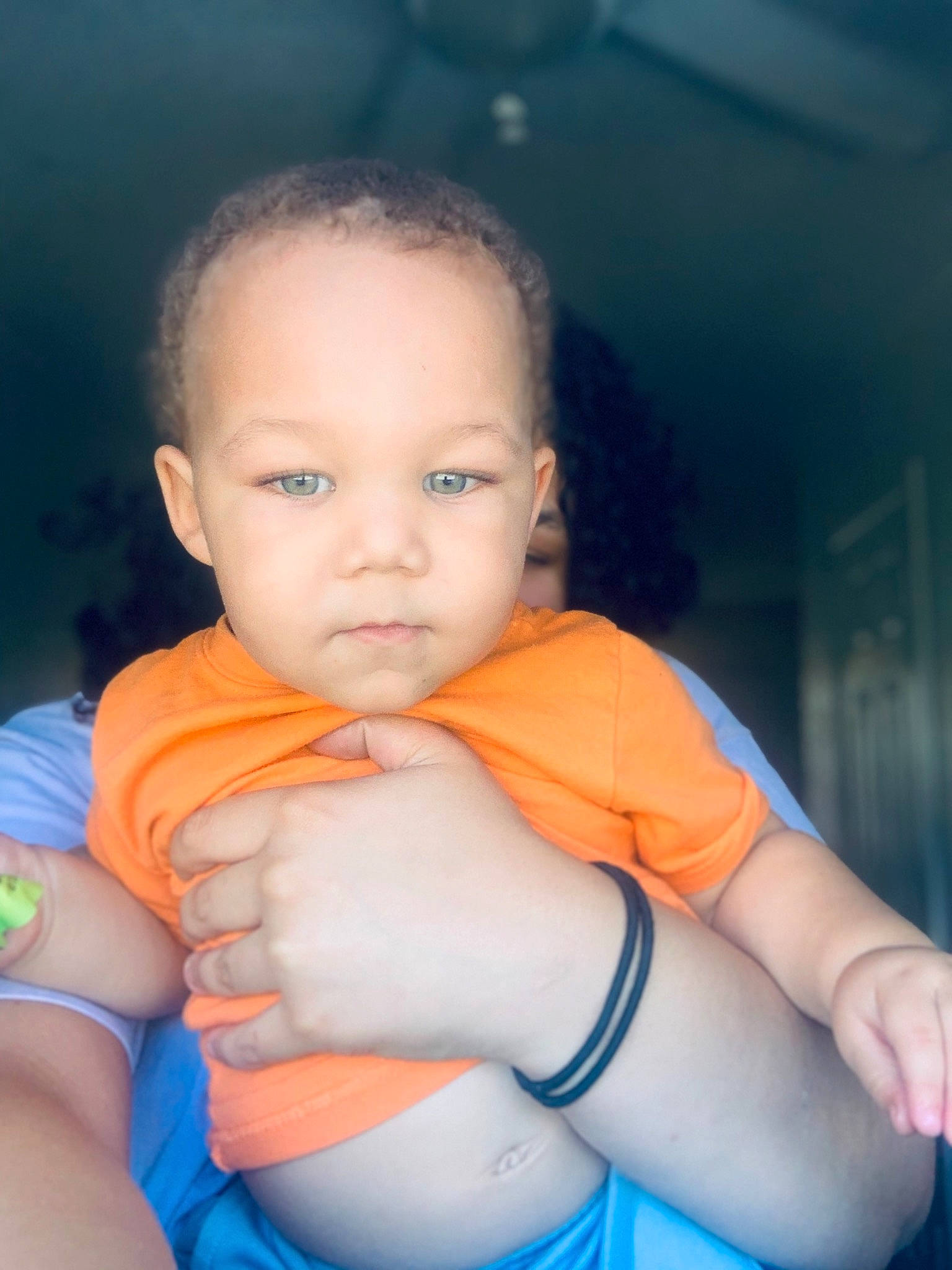 Kaleb is registered to the contest to win money with this photo: abdomen, arm, baby, blue, cheek, child, eye, face, fun, hand, head, lip, muscle, neck, nose, orange, person, skin, smile, stomach
