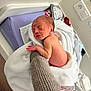 Eden participe au concours pour gagner de l'argent avec cette photo : newborn, baby, sleeping, hand, blanket, hospital, towel, skin, infant, bed, knitted_sleeve, resting, person, indoors, medical, delicate, child, supporting_hand, diaper, peaceful