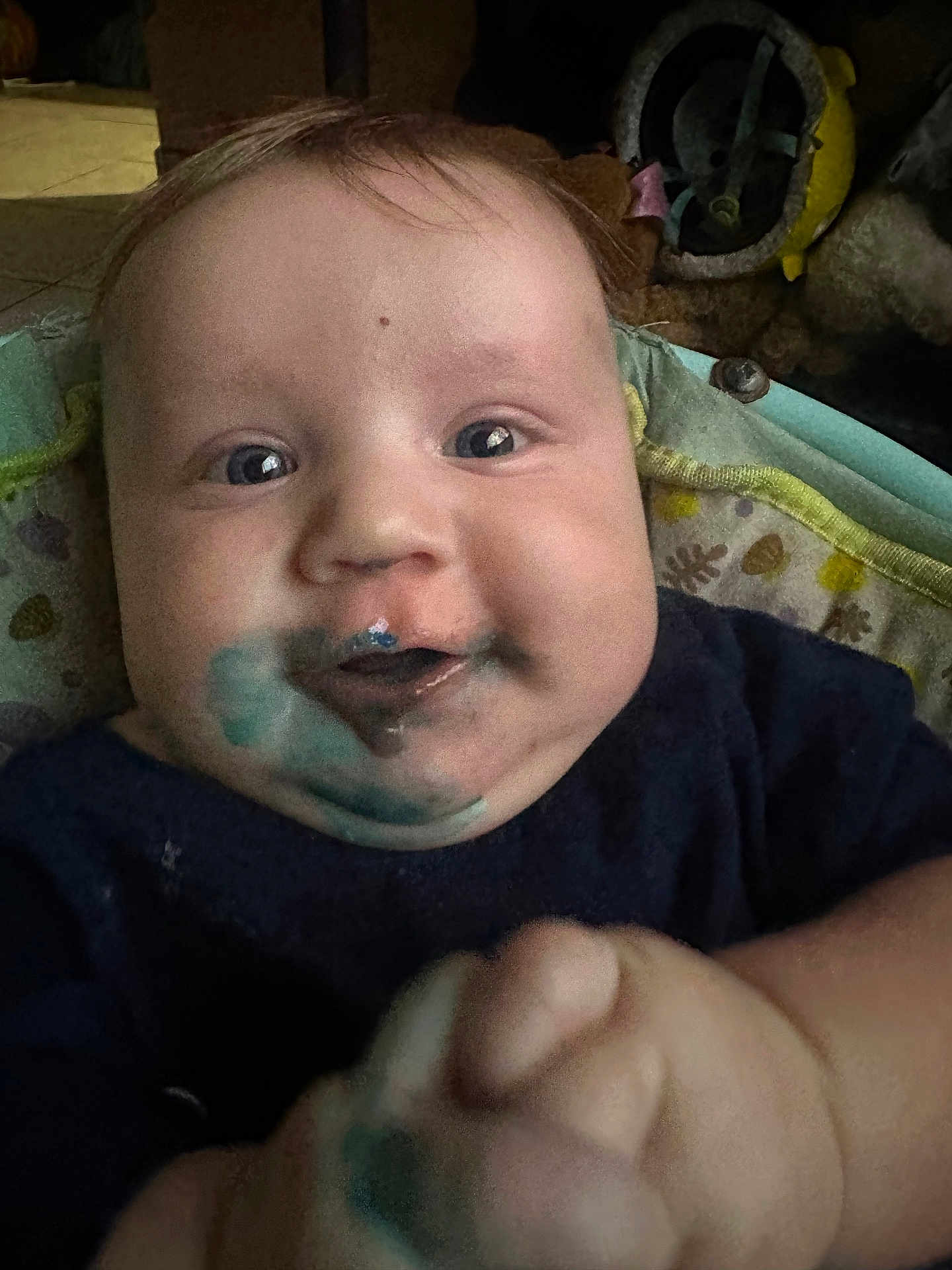 Zabel Carroll is registered to the contest to win money with this photo: baby, child, face, blue_paint, smile, hand, closeup, indoor, clothing, infant, cheeks, eyes, skin, expression, person, young, cute, messy, playful, portrait