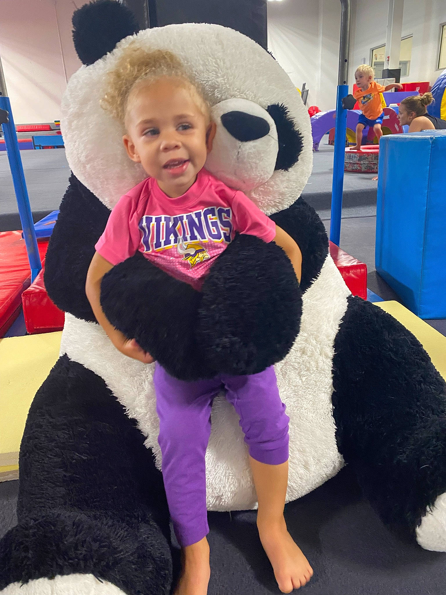 Riley joined the competition — help win amazing prizes! baby, blue, blurred, costume, electric_blue, flooring, foot, fun, fur, happy, leisure, mammal, mascot, organ, person, purple, recreation, smile, t_shirt, thigh