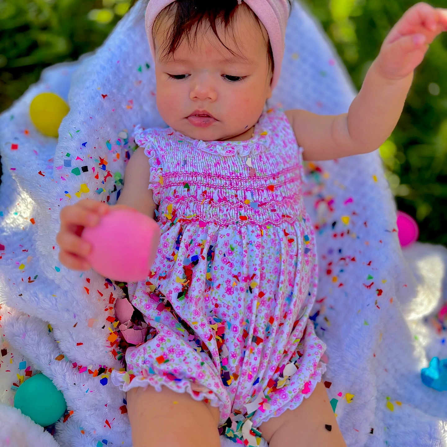 Alaia is registered to the contest to win money with this photo: baby, balloon, blanket, bodypart, clothing, cream, dress, face, finger, hand, happy, hat, head, person, photography, portrait, purple, quilt, smile, towel