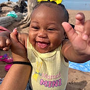 Eanaria joined the competition — help win amazing prizes! baby, child, smiling, yellow_bow, shirt, mamas_mini, hand, beach, sand, driftwood, blue_sky, outdoor, person, happy, cute, portrait, infant, reaching, denim, sunlight