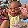 baby, child, smiling, yellow_bow, shirt, mamas_mini, hand, beach, sand, driftwood, blue_sky, outdoor, person, happy, cute, portrait, infant, reaching, denim, sunlight
