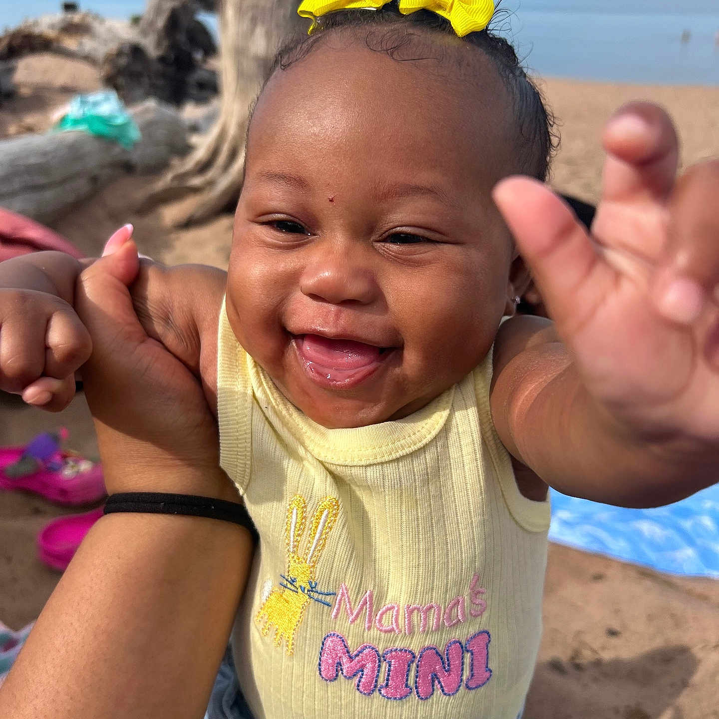Eanaria joined the competition — help win amazing prizes! baby, beach, blue_sky, child, cute, denim, driftwood, hand, happy, infant, mamas_mini, outdoor, person, portrait, reaching, sand, shirt, smiling, sunlight, yellow_bow