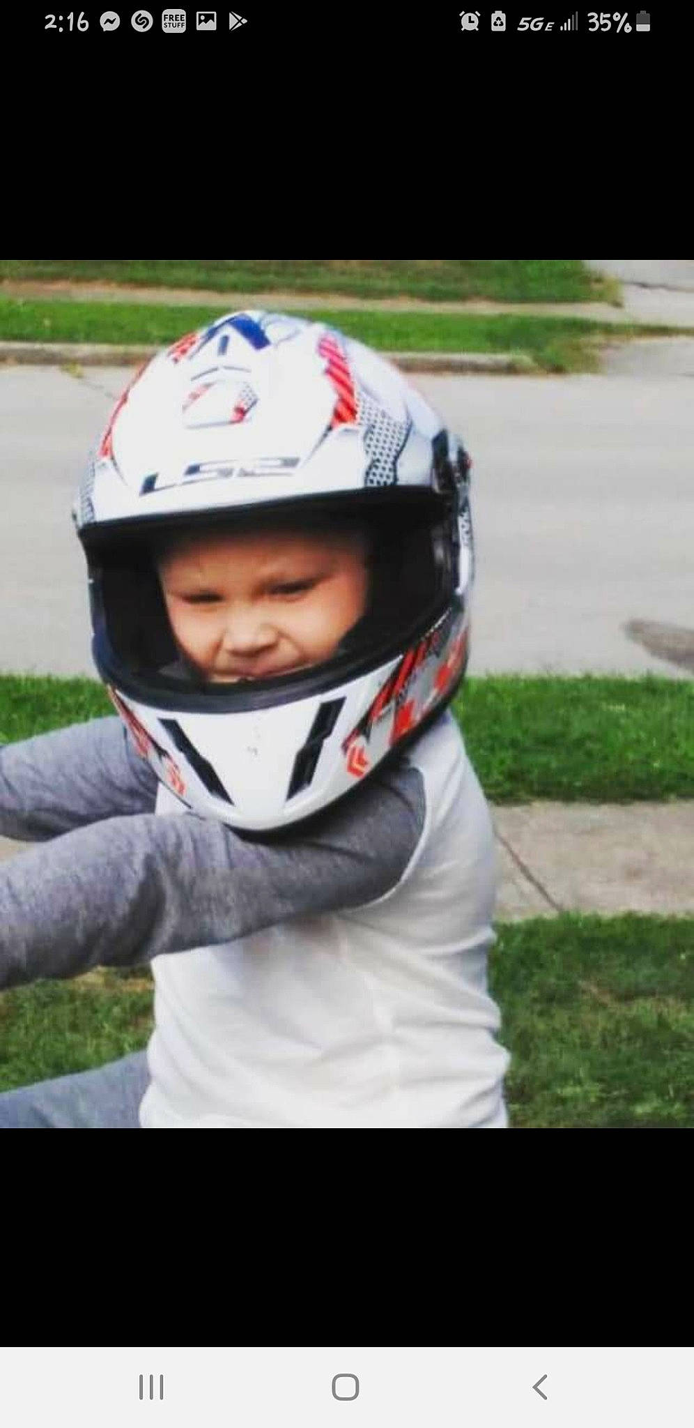 Quintin is registered to the contest to win money with this photo: automotive_exterior, automotive_lighting, carmine, competition_event, costume, eye, eyewear, fashion_accessory, grass, headwear, helmet, leisure, motorcycle_helmet, person, personal_protective_equipment, plant, player, recreation, sports_equipment, sports_gear