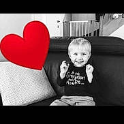Lorenzo participe au concours pour gagner de l'argent avec cette photo : child, smile, blonde_hair, couch, leather, pillow, heart_emoji, baby_gate, staircase, black_and_white, indoor, happy, sitting, clothing, person, living_room, home, casual, playful, young