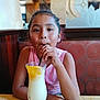 Maryfer is registered to the contest to win money with this photo: beverage, booth, casual_clothing, child, dining, drink, eyes, face, girl, glass, hair, hands, lemon_slice, pink_shirt, portrait, restaurant, seat, smiling, straw, table