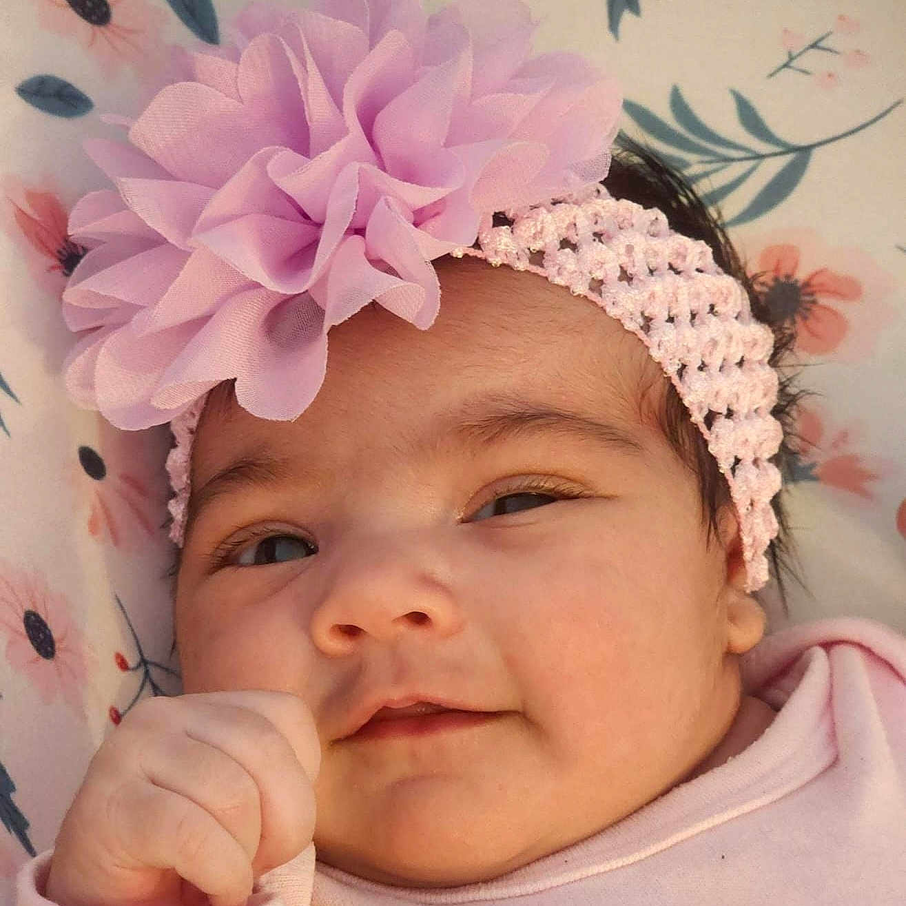 Kelly Reboso is registered to the contest to win money with this photo: baby, blanket, child, closeup, clothing, cute, face, flower, hand, headband, indoors, infant, newborn, person, pink, portrait, resting, skin, smile, soft_texture