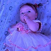 Addie is registered to the contest to win money with this photo: baby, infant, child, baby_girl, dress, tulle, bow, hair_bow, hand_in_mouth, lying_down, crib_sheet, animal_print, elephant, giraffe, lion, pink, purple_lighting, portrait, cute, soft_textile