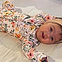 Malia joined the competition — help win amazing prizes! baby, child, smile, floral, onesie, headband, bow, bed, happy, cute, infant, lying_down, clothing, person, portrait, indoors, soft, skin, hair, face