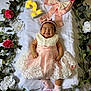 baby, smiling, dress, pink, white, lace, headband, flower, floral_wreath, number_two, celebration, socks, happy, infant, cute, portrait, laying_down, decor, greenery, indoors