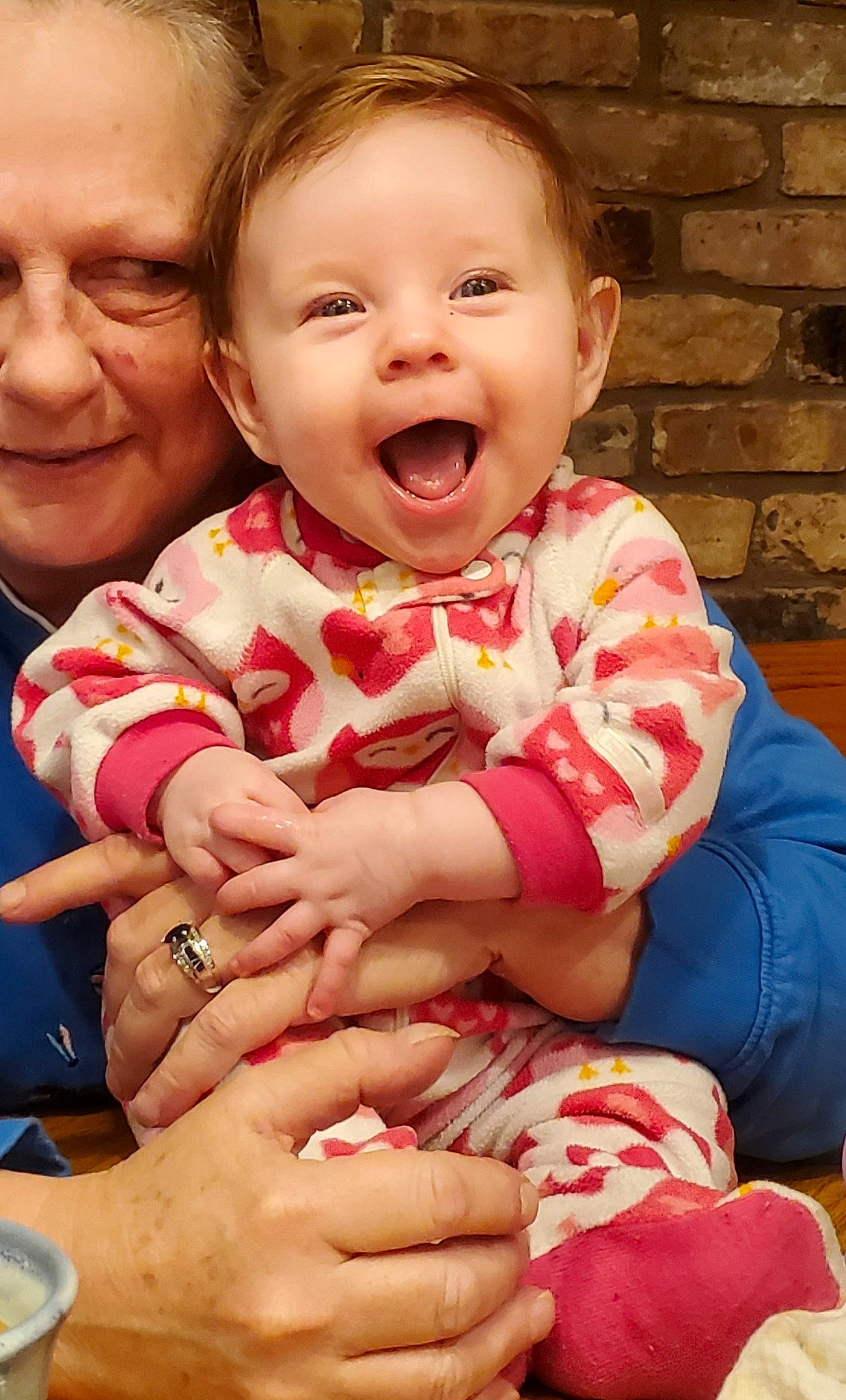 Atlantis is registered to the contest to win money with this photo: baby, baby_toddler_clothing, cheek, eye, face, facial_expression, finger, gesture, hand, happy, head, human_body, joy, mouth, person, photograph, pink, red, skin, sleeve