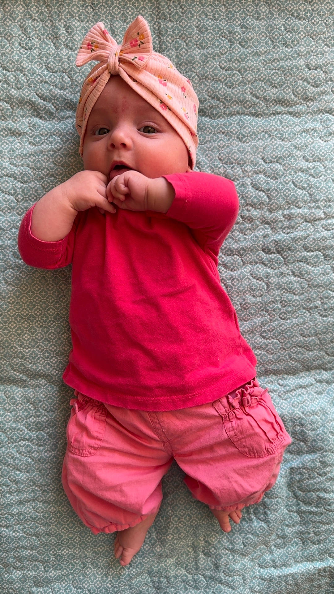 baby, blanket, bodypart, bonnet, cap, clothing, dress, face, finger, hand, hat, head, homedecor, newborn, pants, person, photography, portrait, quilt, shorts