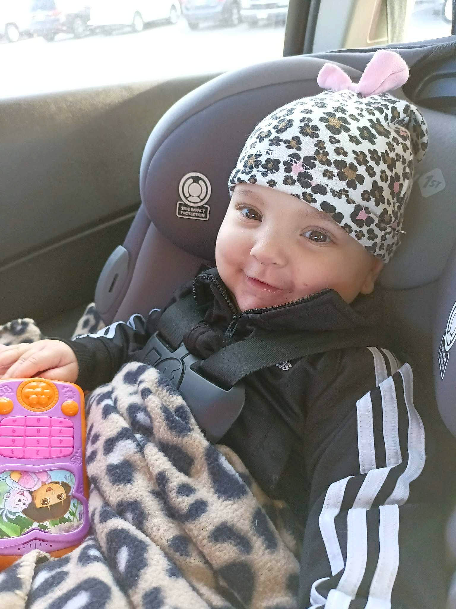 Jocelyn is registered to the contest to win money with this photo: auto_part, automotive_exterior, baby, baby_toddler_clothing, cap, car, car_seat, car_seat_cover, child, comfort, cool, face, family_car, fashion_accessory, happy, head_restraint, headwear, joy, motor_vehicle, person