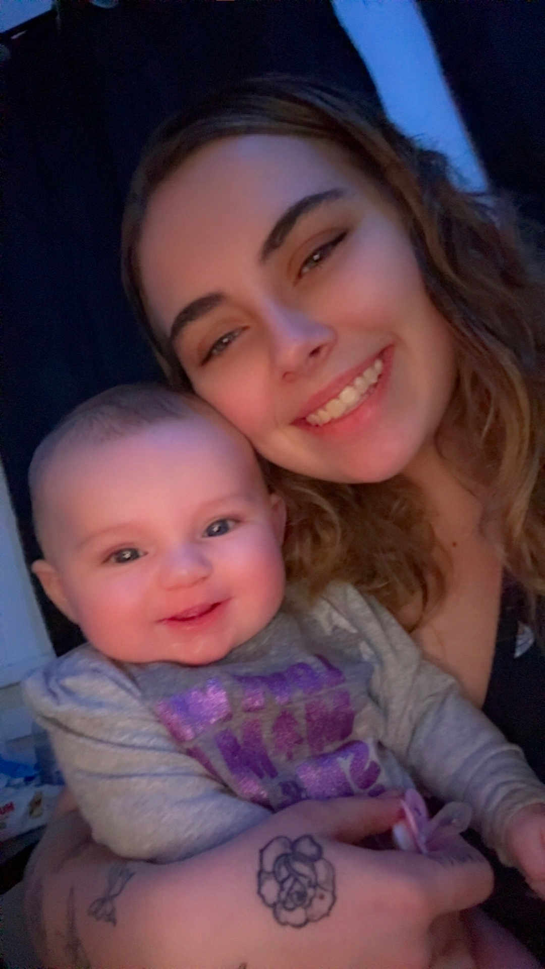 Camilla is registered to the contest to win money with this photo: baby, child, woman, smile, happy, portrait, face, indoor, person, holding, tattoo, clothing, long_hair, cute, closeup, family, love, skin, head, cheerful