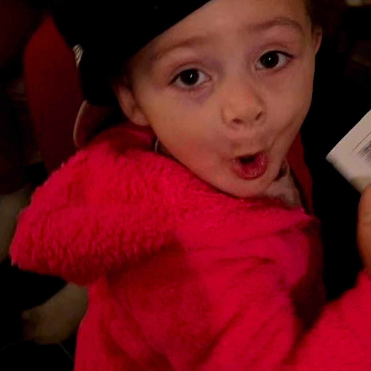 Brealyn is registered to the contest to win money with this photo: child, clothing, cute, expression, face, fun, fuzzy_texture, hand, hat, holding, indoor, looking_at_camera, mouth_open, person, pink_jacket, playful, portrait, warm_clothing, wide_eyes, young