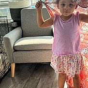 Brealyn joined the competition — help win amazing prizes! child, girl, barefoot, blanket, pink_shirt, floral_skirt, indoor, living_room, armchair, window, sunlight, wooden_floor, basket, pet_crate, curtain, home, person, standing, expressionless, casual_clothing