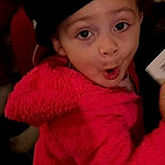 Brealyn is registered to the contest to win money with this photo: child, pink_jacket, hat, face, expression, surprise, card, hand, indoor, person, clothing, cute, portrait, young, eyewear_absent, headwear, warm_clothing, closeup, emotion, playful